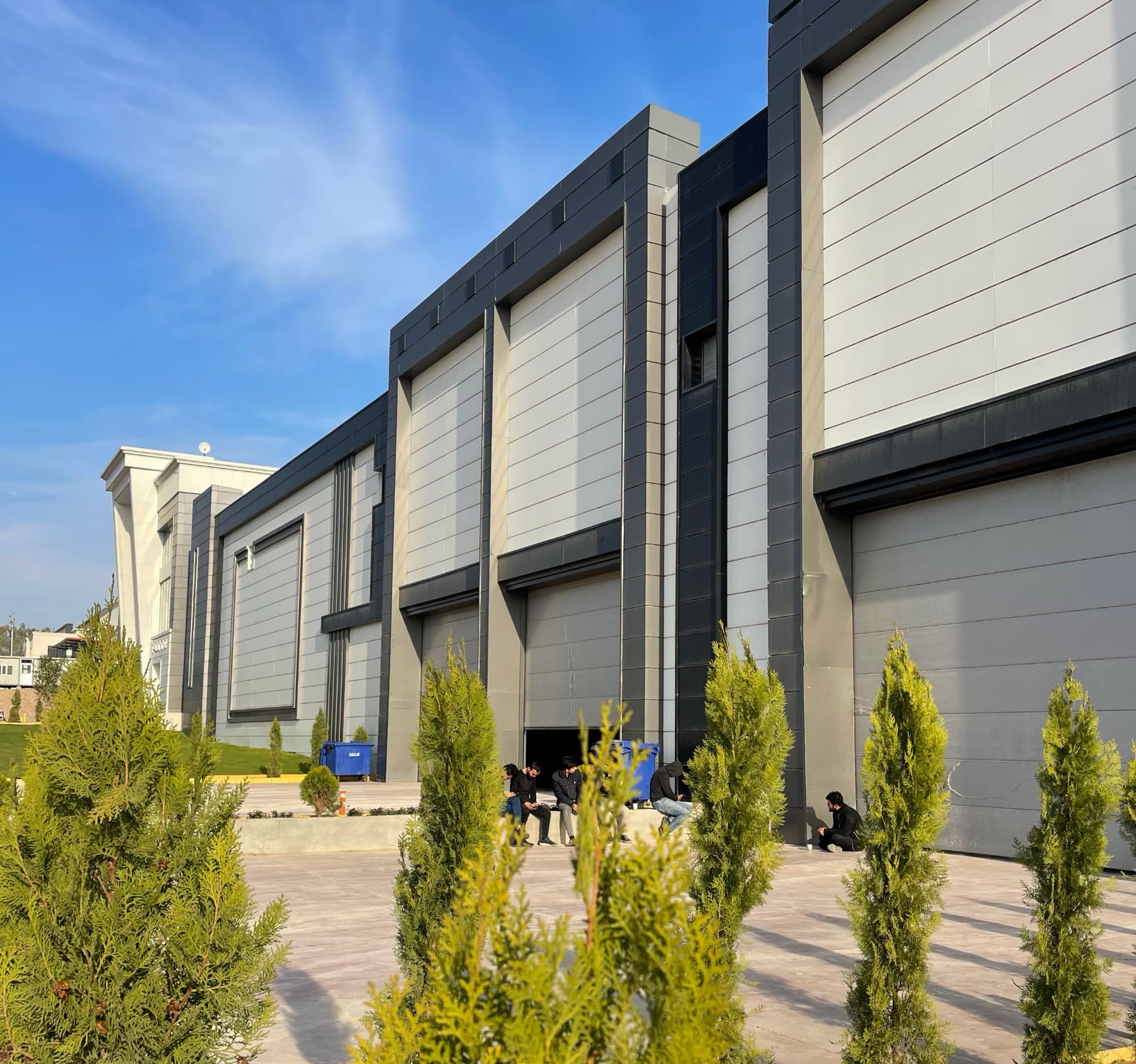 Industrial building with a row of automated sectional doors