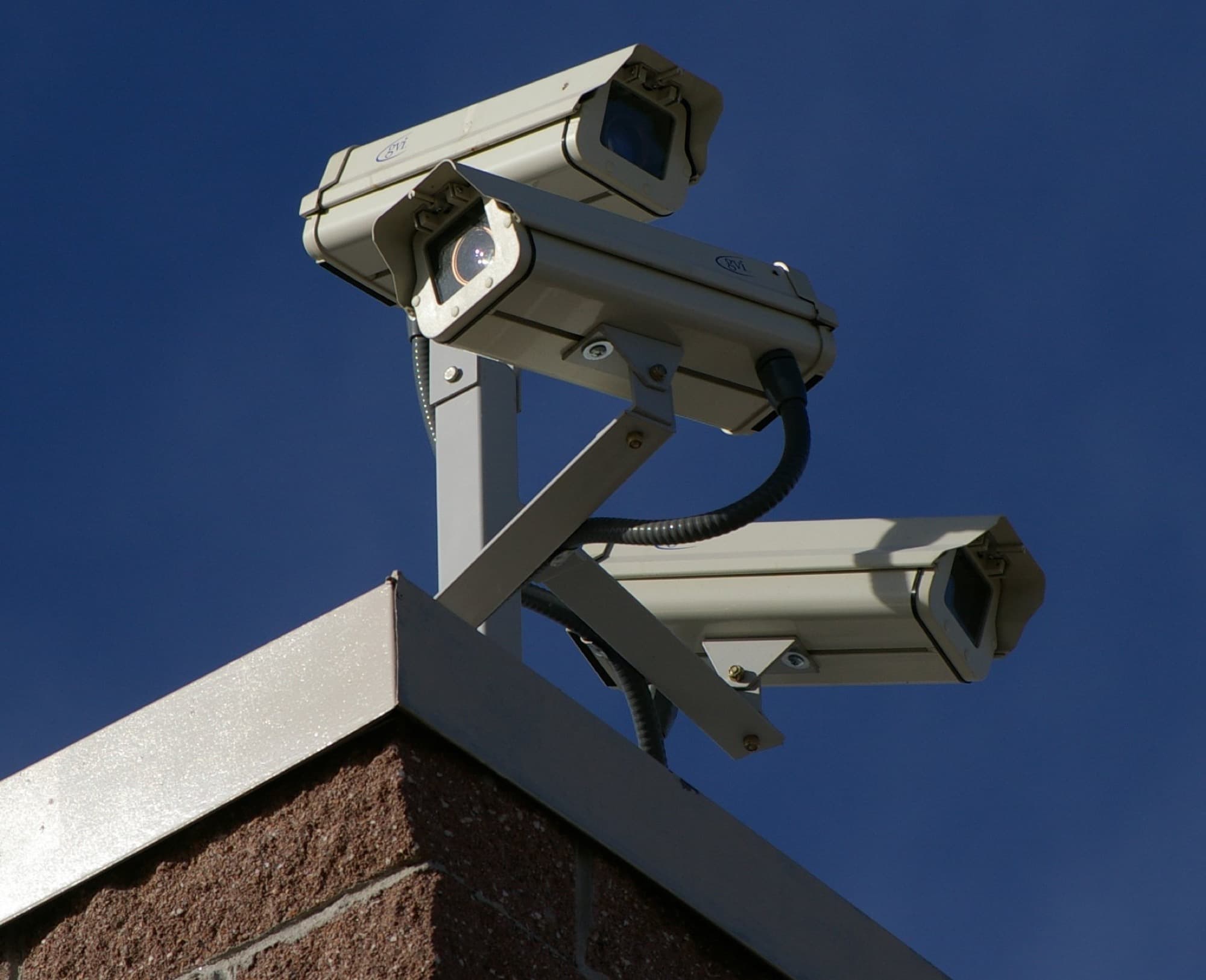 Cluster of surveillance cameras mounted on the corner of a building
